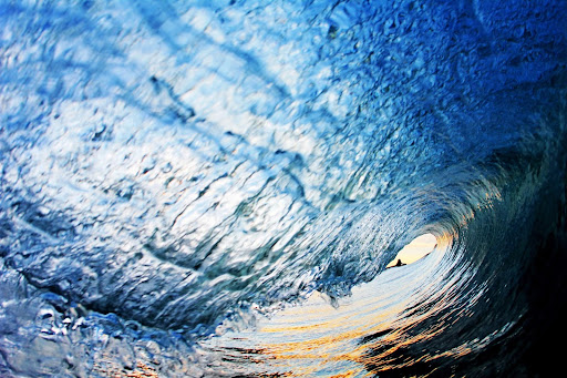 Sunset inside of a breaking wave