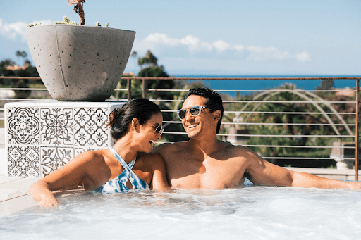A couple relaxing in a hot tub overlooking the ocean at one of the world renowned Dana Point Hotels and Resorts 