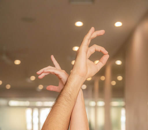 A picture of Two hands in the air holding a pose at the Blend OC